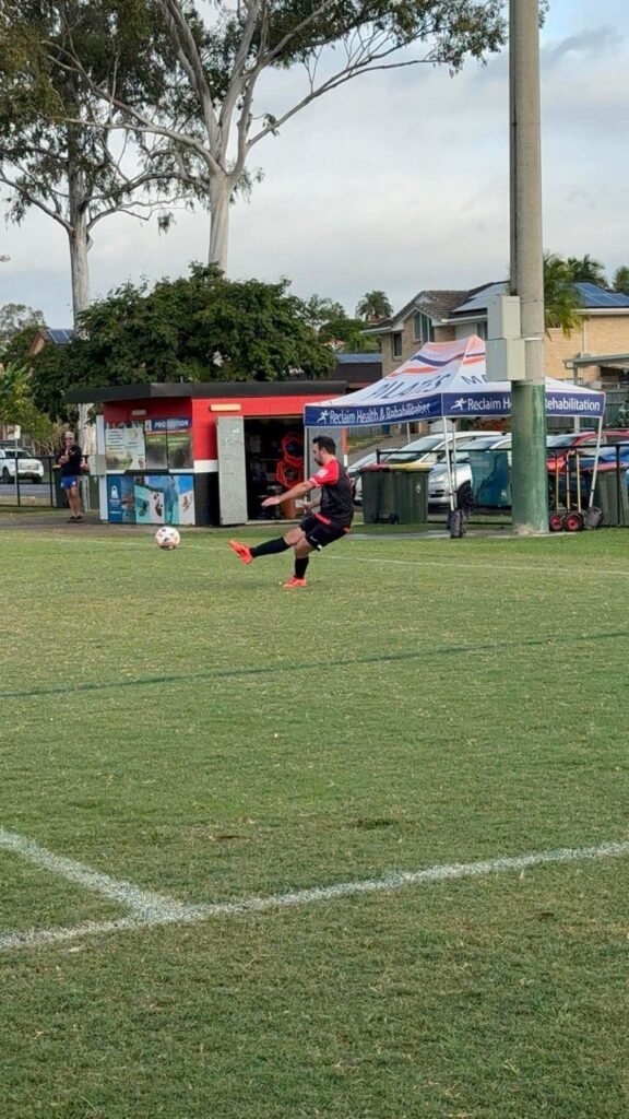 Holy Cross FC President crossing the ball from the wing during a match